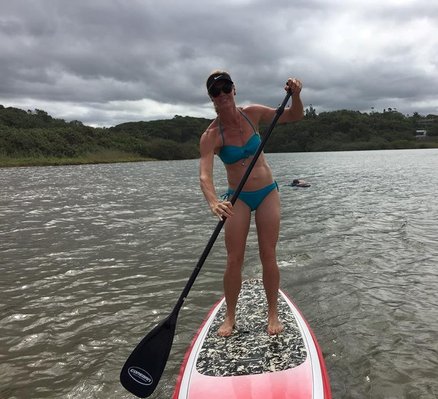 Fit woman paddling standing